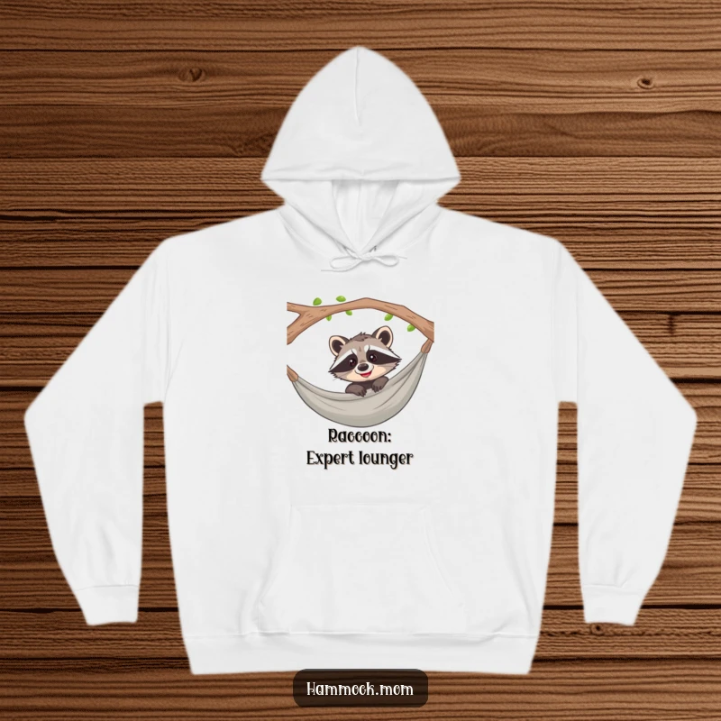 Funny raccoon peeking from a hammock with a curious, mischievous grin on a cozy hoodie, perfect for loungewear.