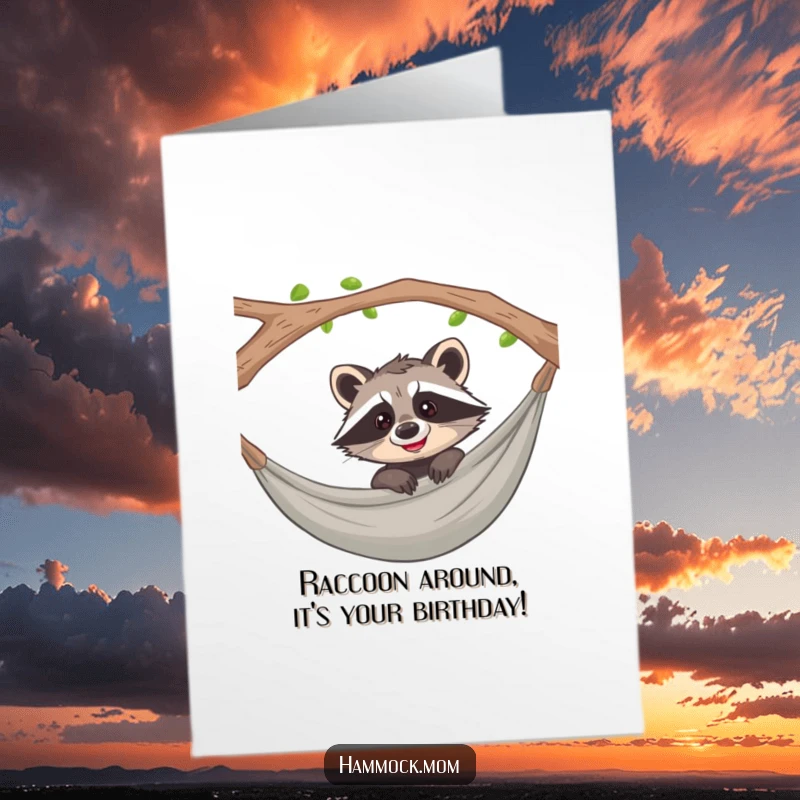 Funny Free Printable Birthday Card: Playful raccoon peeking over hammock, grinning mischievously, ready for fun.